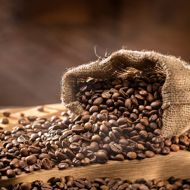 istock spilled coffee beans in bag on wood 505059626
