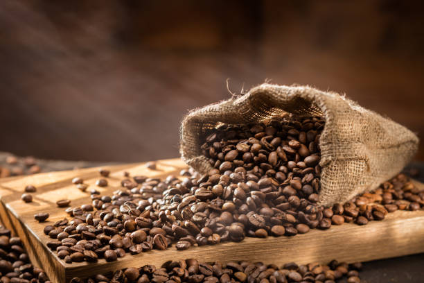 istock spilled coffee beans in bag on wood 505059770