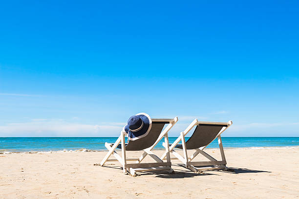 istock Two deck chairs and hat, relaxing on the beach, sunny 505060132