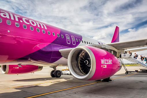 Poznań, Poland - August 06, 2014: The Wizzair plane Boeing 737-800, few minutes before the departure, is parked in the airport of Ławica Airport in Poznań destined for Barcelona, Spain