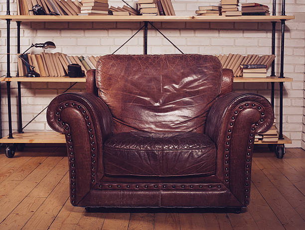 istock Classic Brown leather armchair in  library 505062800