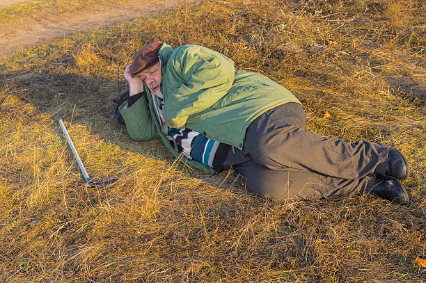istock Senior hiker has short rest lying on the roadside 505063996
