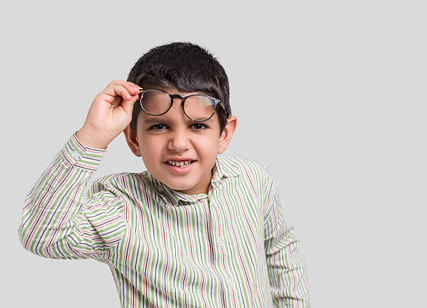 istock Little boy peering over his glasses 505064658