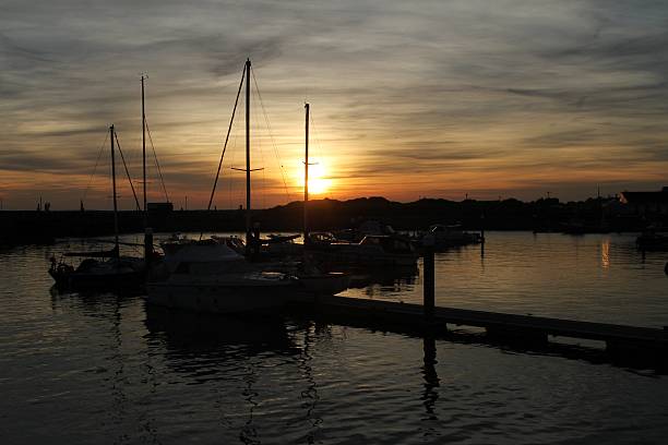 istock Sailing ships in harbour at sunset 505065438