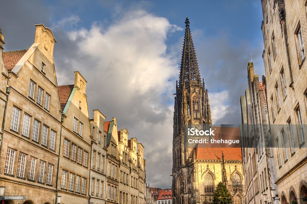 Tower of Saint Lamberti Church in Munster, Germany Gables of historical houses and the tower of Saint Lamberti Church in the Prinzipalmarkt street in Munster, Germany Muenster - Germany Stock Photo