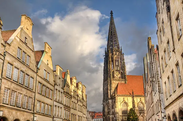 Gables of historical houses and the tower of Saint Lamberti Church in the Prinzipalmarkt street in Munster, Germany