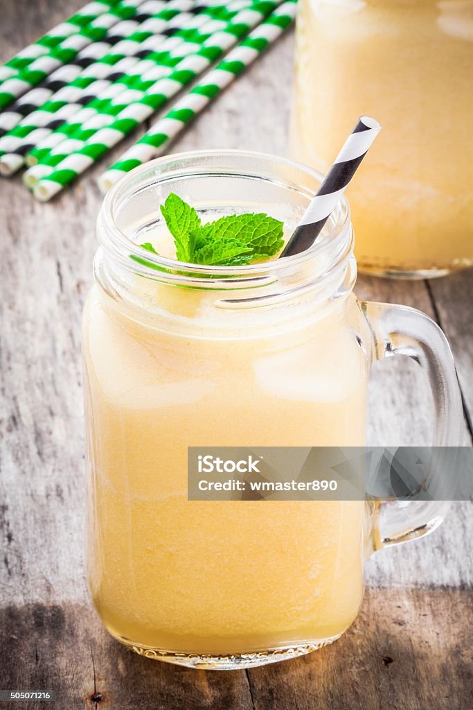 melon smoothie in a glass jar with mint melon smoothie in a glass jar with mint and straw Airtight Stock Photo