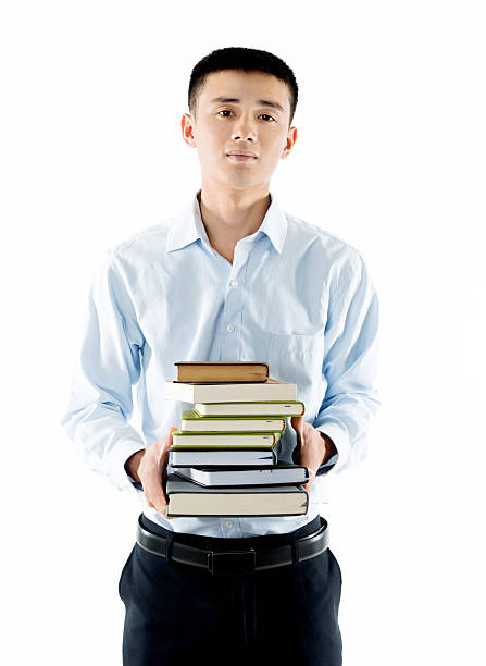 istock Young man with many books 505071874