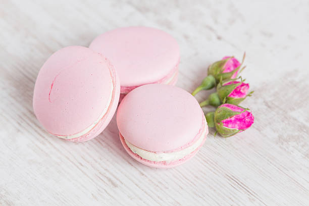 istock Tender pink macaroons on white wood background 505080041