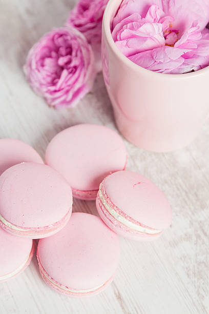 istock Tea cup with rose and pink macaroons 505080359