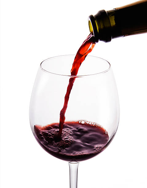 istock Pouring red wine into glass. Isolated on white. Clipping path 505080753