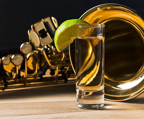 Photo of saxophone and tequila with lime