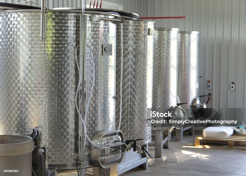 Stainless Tanks in New Winery A row of new stainless steel tanks in a new winery. Ontario - Canada Stock Photo