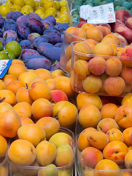 istock Apricots in plastic bowls on a corner market 505084787