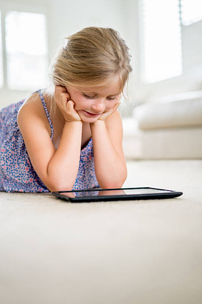 istock Girl watching videos on a tablet 505085184