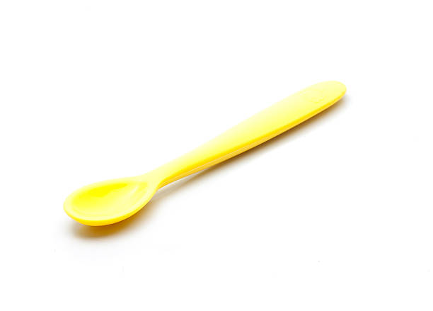 istock Yellow silicone baby spoon on white background 505085728
