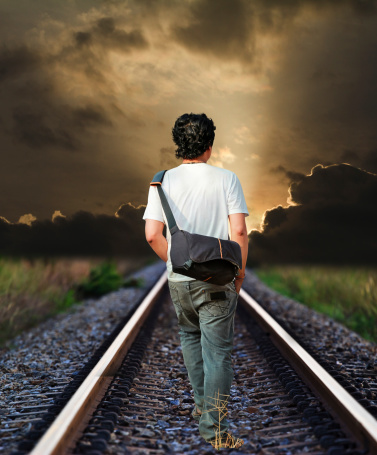 man walking on the railway tracks