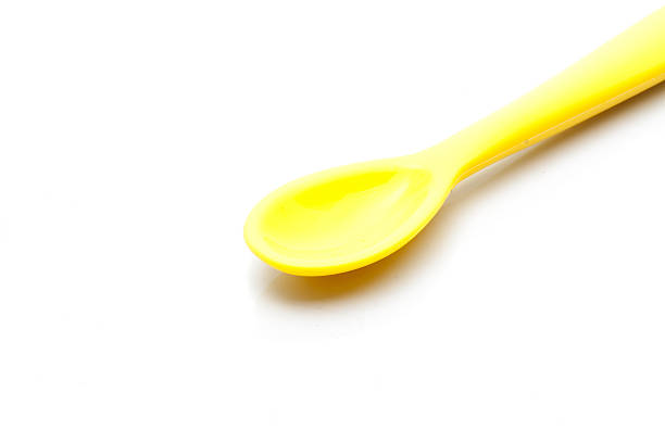 istock Yellow silicone baby spoon on white background 505085854