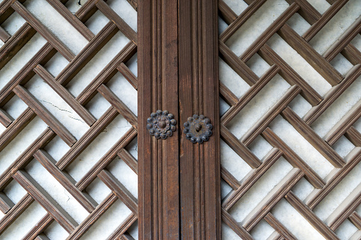 traditional small door knob with wooden patterns in namsangol hanok village in seoul, south korea.