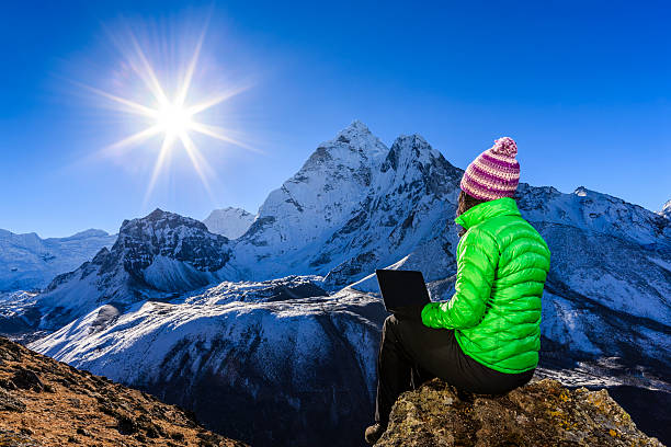 istock Young woman using laptop in Himalayas, Nepal 505089234