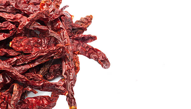istock dried chili peppers on white background 505089698