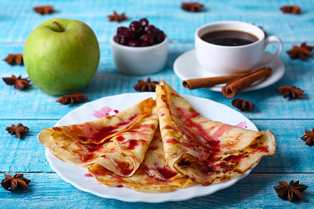 istock Breakfast pancakes with cherry jam on a blue background 505093130