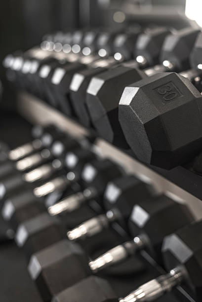 istock rack of desaturated dumbbell weights in gym 505093256