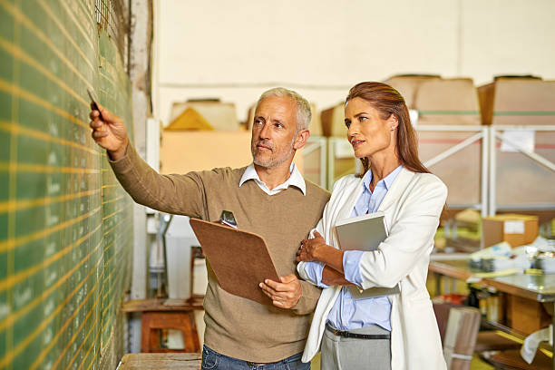 istock Coworkers working in warehouse and checking statistic 505095418