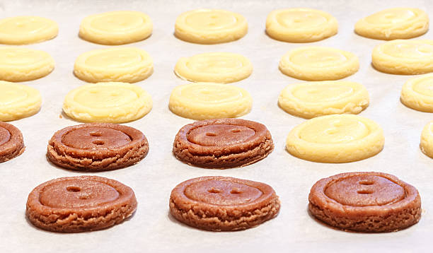 istock Raw dough. Yellow and brown cookies buttons. 505095882
