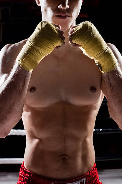 istock Skillful young boxer is showing his fists 505101710
