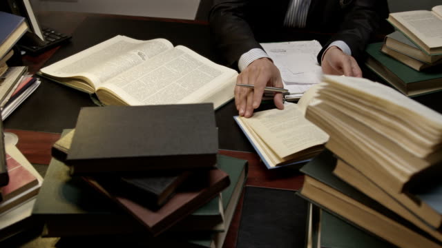 Lawyer exploring books in the working room. Shot on RED EPIC Cinema Camera.