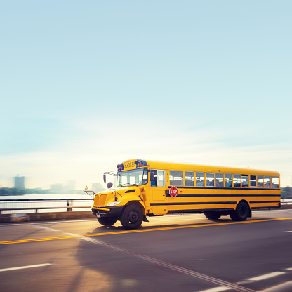 Yellow school bus crossing a bridge