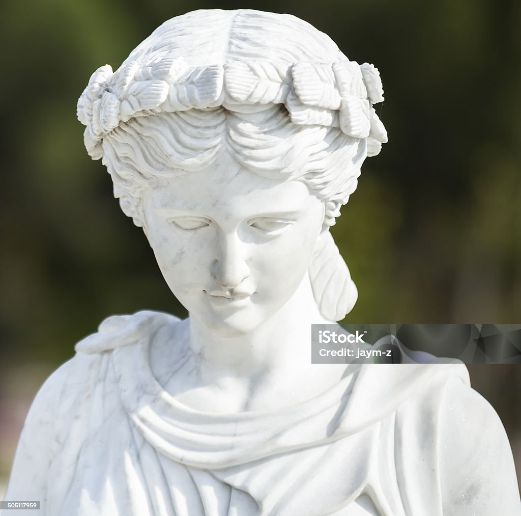 Ancient Beauty Marble sculpture of a pleasant woman. Statue Stock Photo