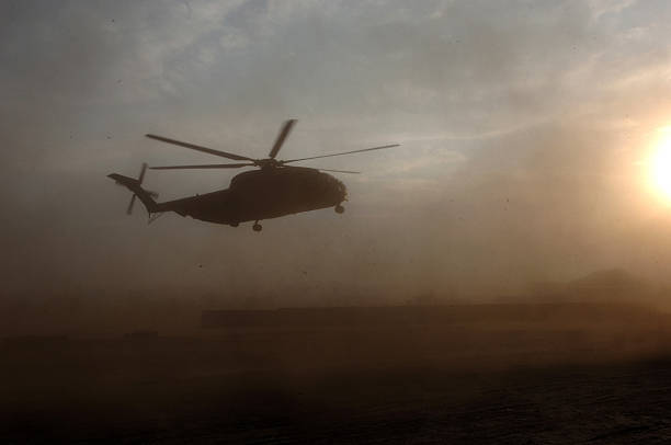 istock Military Helicopter landing in war zone 505120539