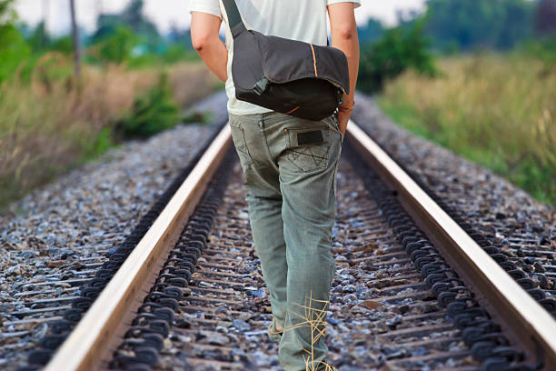istock man walking on the railway tracks 505121635