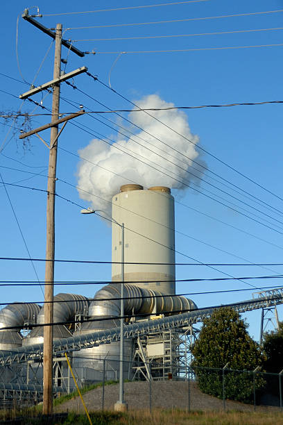 istock Steam power station cooling tower with power lines in foreground 505122694