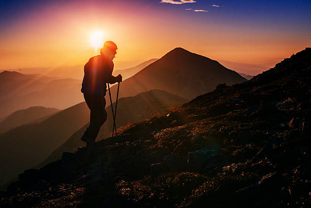 istock tourist in the mountains at sunset 505124160