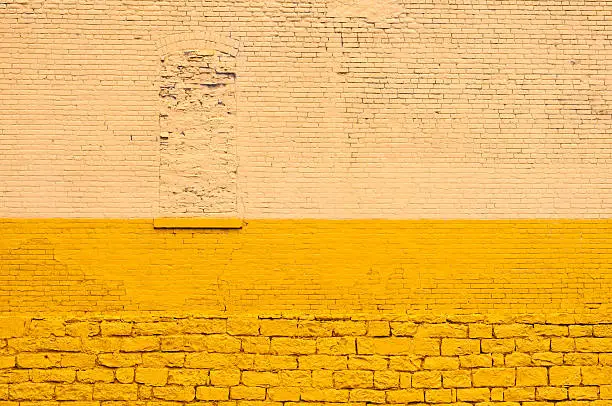 An old brick wall in Cleveland, Ohio, painted yellow