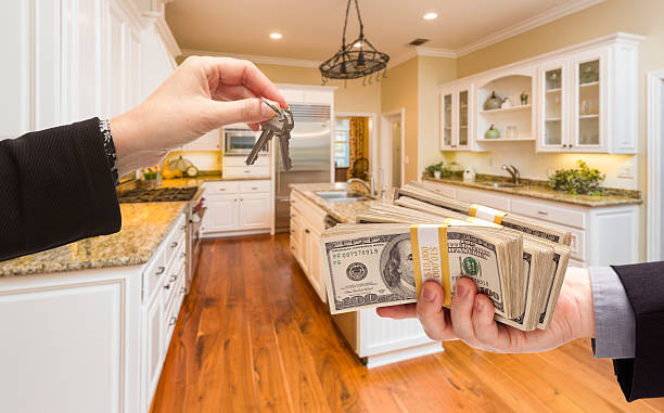 Handing Over Cash for Keys Inside Beautiful Kitchen