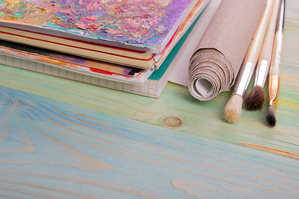 istock Colorful artistic paintbrushes, pencils on wooden deck table background 505132218