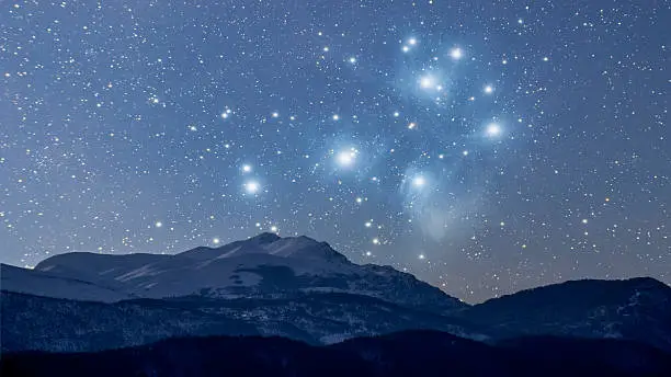 This is a combination of two photos taken separately, one of a mountain range, the other of Pleiades. Pleiades are out of proportion and the idea is to depict how it would look if the Deep Space Objects are closer to us, bigger and more visible.