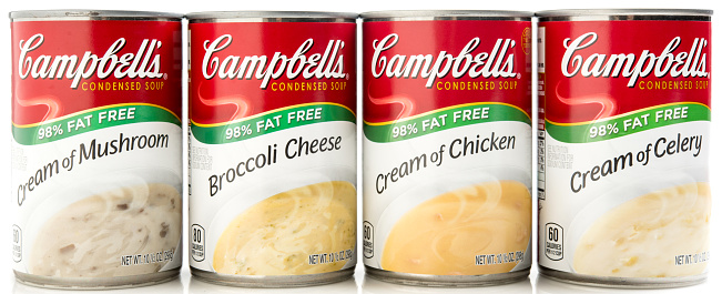 Miami, Florida, USA - May 27, 2015: Four Assorted Campbell's Condensed Cream Soup cans on White Background in a row. Campbell Soup Company is a global food company headquartered in Camden, N.J., with annual sales of more than $8 billion