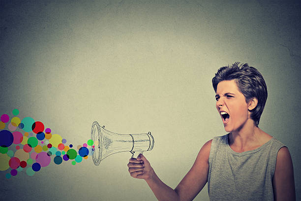 istock angry screaming young woman holding megaphone 505135814