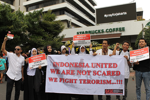 Jakarta, Indonesia - January 15, 2016: Peoples held a peace rally in Sarinah to condemn terrorist attacks that occured on January 14, 2016 in the same location and pray for the victims which dead and wounded. They also invite other people to against and not afraid to fight any kind of terrorism.