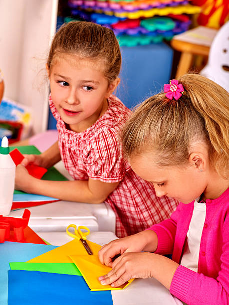 istock Nice kids holding origami airplane in kindergarten 505136856