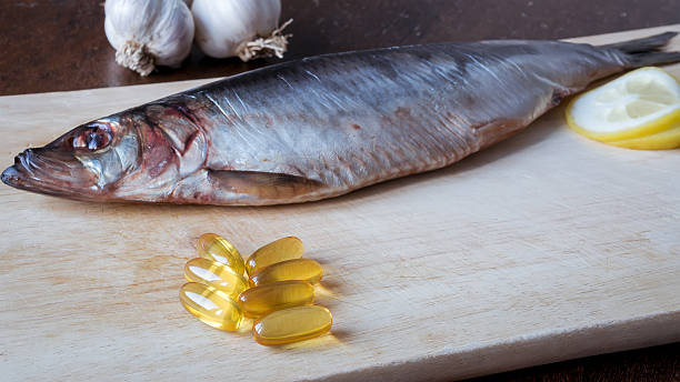 istock Fish oil pills and fish 505139812