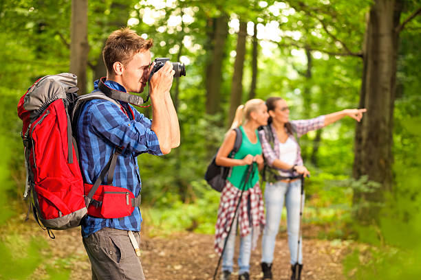 istock photographer taking photo during hike 505142117