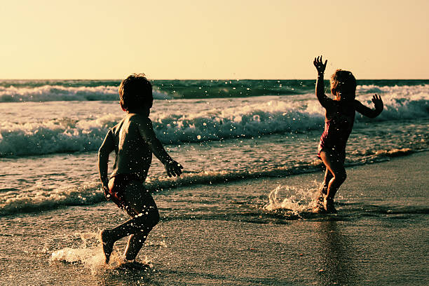 istock two happy kids playing on the beach 505142647