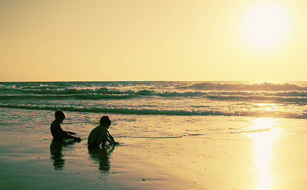 istock two happy kids playing on the beach 505142693
