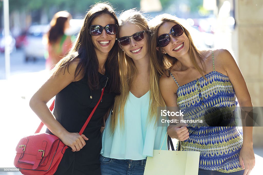 Group of beautiful young girls in the street. Shopping day. Outdoor portrait of group of beautiful young girls in the street. Shopping day. Adult Stock Photo